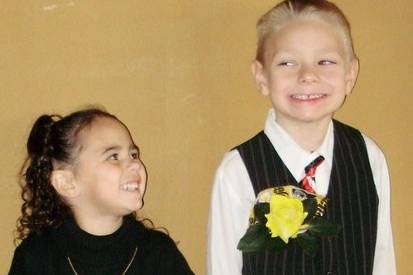 The flower girl and the ring bearer sharing a moment before the ceremony, so cute.