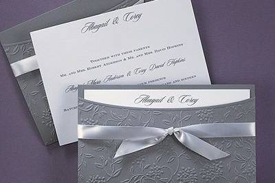 2014 Wedding Trend: Grey - Flowers and Vines - Invitation
The unique Jean M® wrap invitation will stun your guests with a beautiful floral swirl design accented with a satin bow to reveal your invitation inside.
Dimensions: 7 3/4