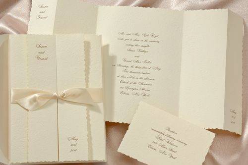 2014 Wedding Trends: Neutral - This ecru invitation is made from felt paper embossed with a subtle floral pattern. Your names are featured at the top and your wedding date is at the bottom. This invitation is held closed by ecru self-adhesive satin bands, which are included.
