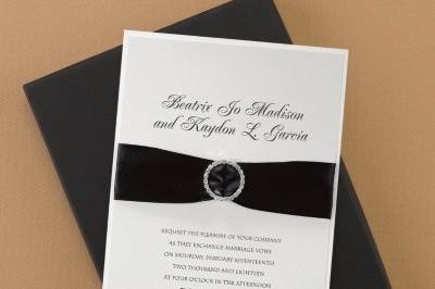 Dressed to the Nines - Invitation: Oozing with glamour and elegance, this invitation features a printed latte shimmer top layer and ecru vellum base card. A black satin ribbon and rhinestone buckle hold them together.
Dimensions: 5 3/4