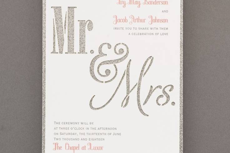 Getting married with glam? Here's the way to announce it: a silver glitter backer card that shows through a die-cut 