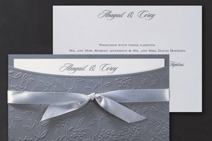 The unique Jean M® wrap invitation will stun your guests with a beautiful floral swirl design accented with a satin bow to reveal your invitation inside.
Dimensions: 7 3/4