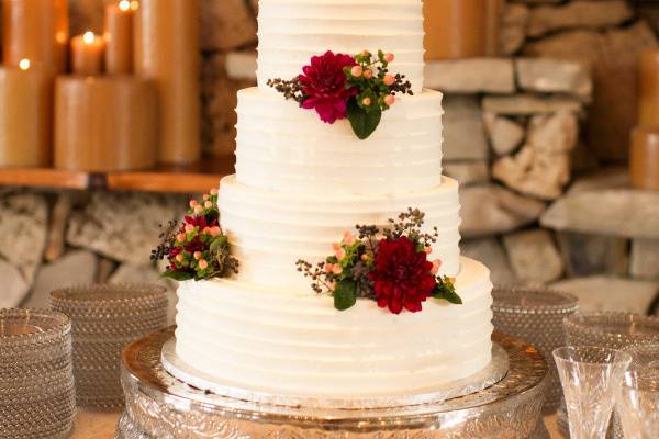 White wedding cake with red roses