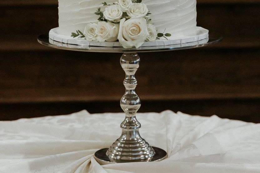 White wedding cake with white roses