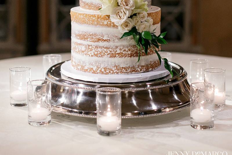 White wedding cake with flowers and grass
