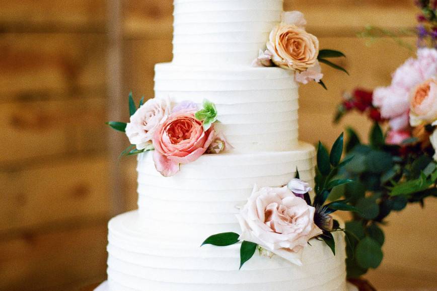 White wedding cake with minimal flowers