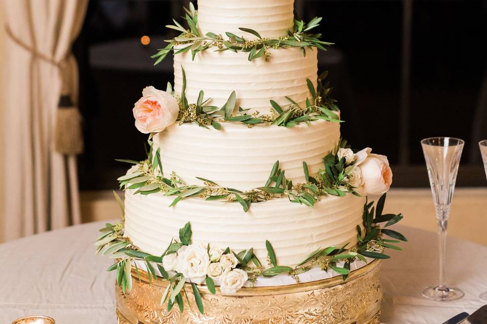 White wedding cake with flowers and grass