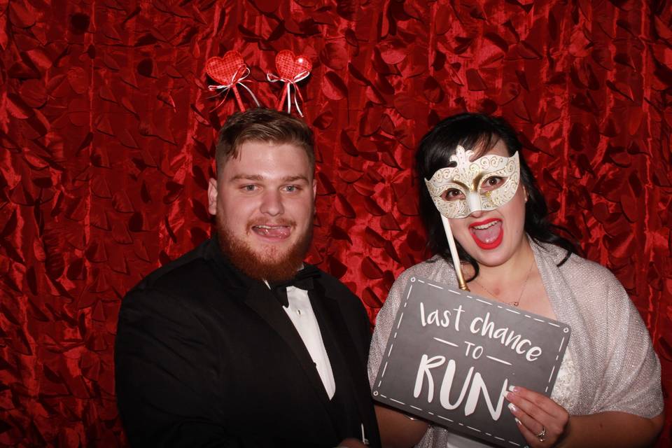 Bride and groom enjoying photo booth