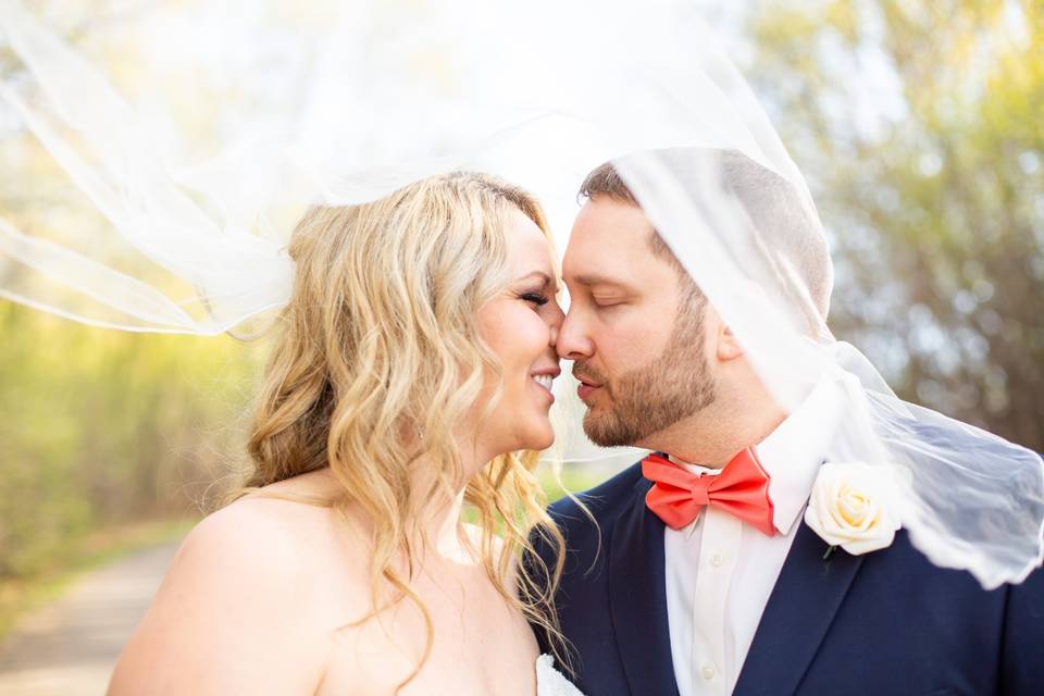 Bride and groom under veil