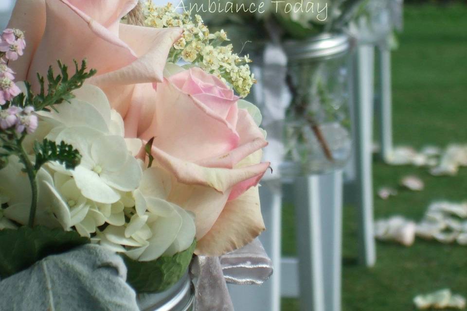 The #vintage, #shabby chic theme continued in the #chair flowers for the #aisle.  #Mason jars were hung with rough, natural twine and filled with #pale, #pastel flowers.