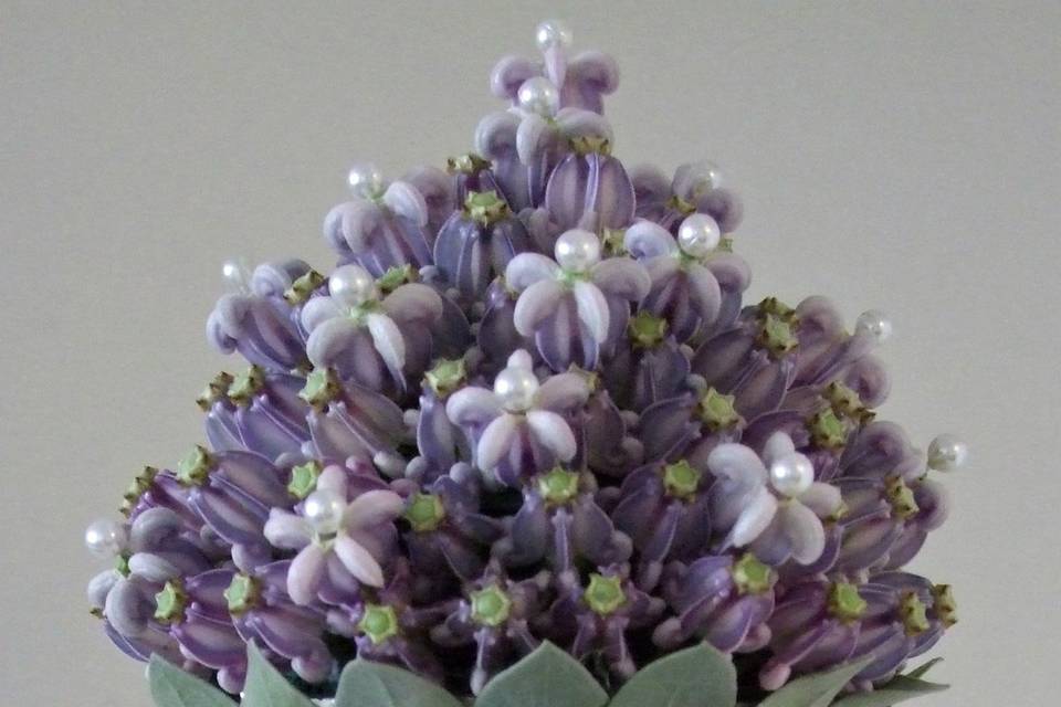 A #scepter style #bouquet made with purple #crown flower and #silvery foliage.