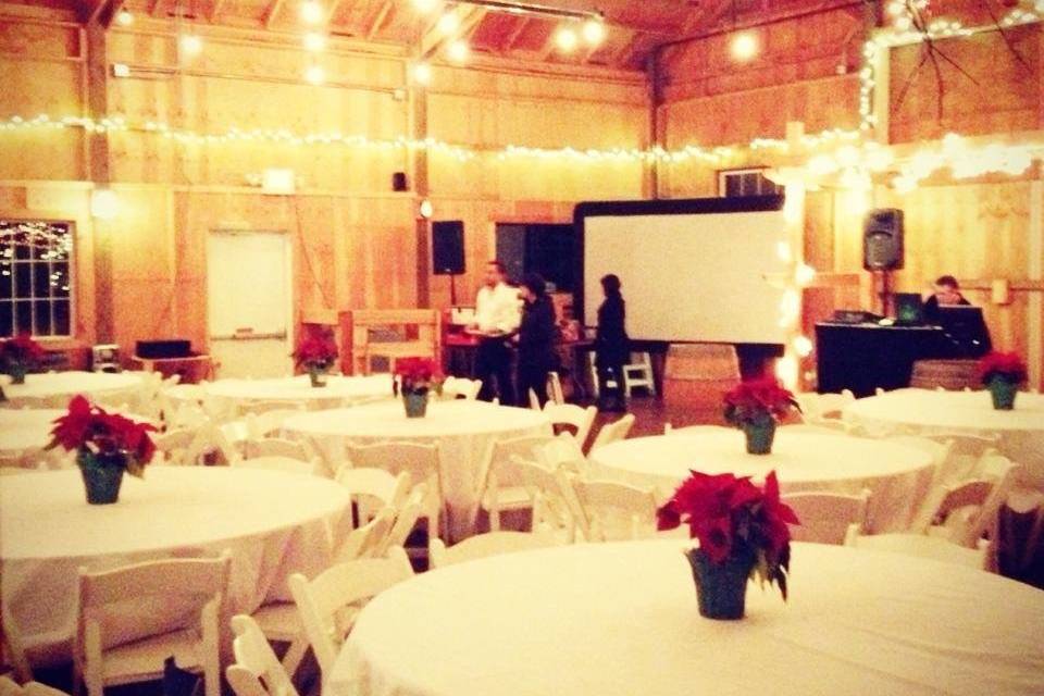 Floral centerpieces and barn lighting