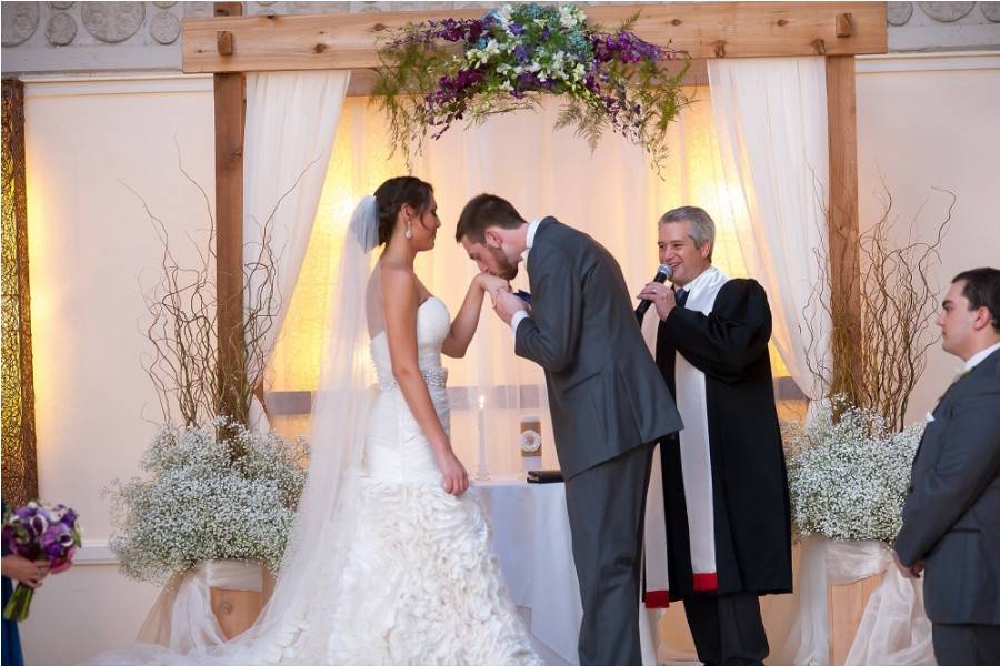 Groom kisses his bride's hand