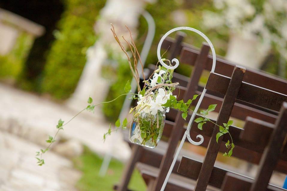 Bride and groom caught in intimate embrace under the bamboo trellis.