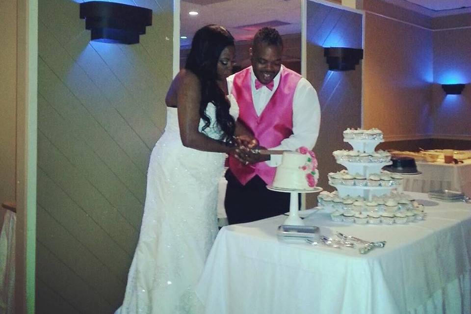 The couple cutting the cake