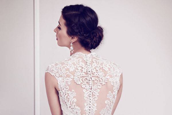 Kenneth Winston 1584- Classic V-neckline gown wrapped with floral arrangements made of Venice Lace creating a bold contrast finished with heavily beaded arch of jewels and crystals. Zipper back.