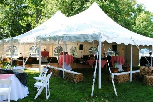 tented wedding reception with hay bales couches with white wood tops