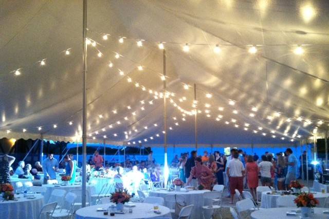 tented wedding reception with hay bales couches with white wood tops