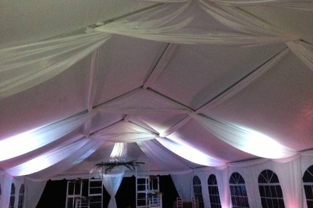 Wedding reception with custom fabric draping and uplighting