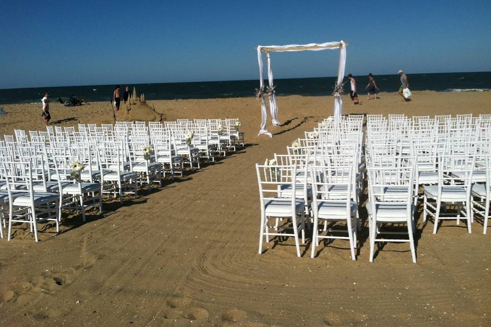 Beach wedding with Large Bamboo Arch and white chivari chairs