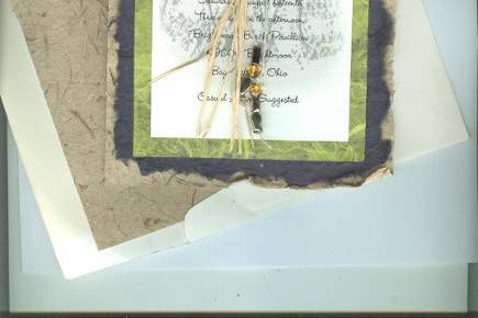 Rustic and fun hand-torn invitation with raffia and glass beads.