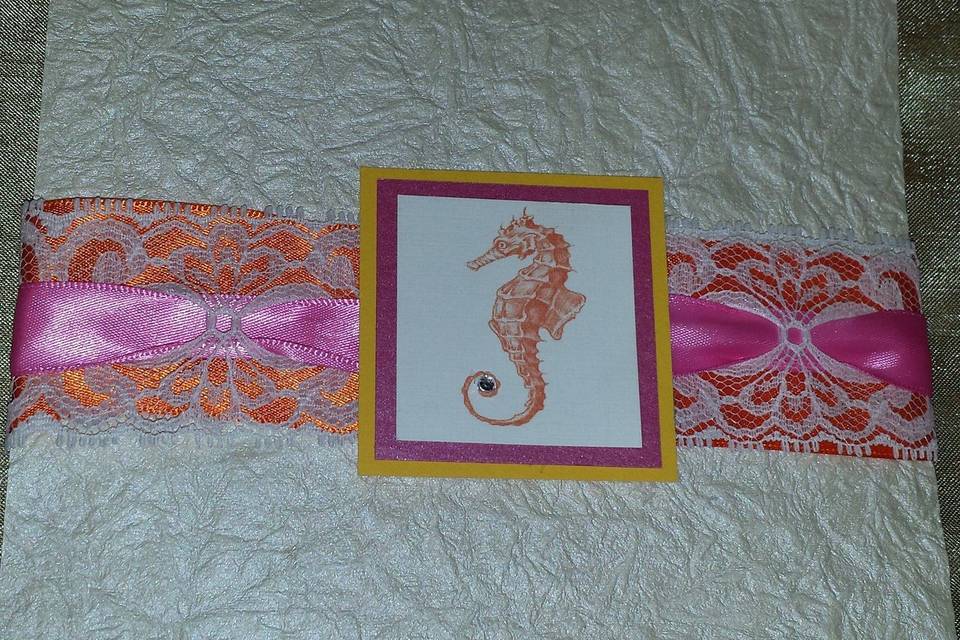 This cute seahorse and colorful backer, with lace and pink ribbon, sets the tone for this fun invitation.