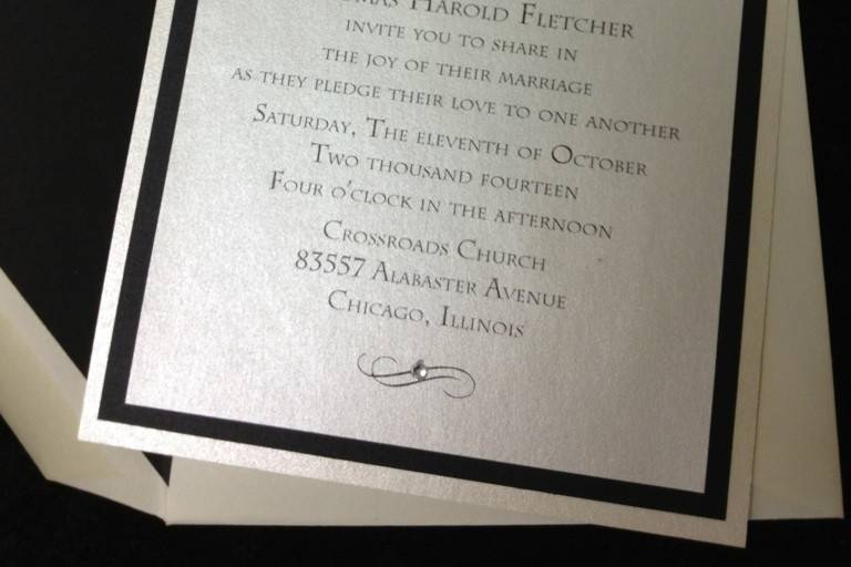 Simple black and white invitation with black lace accent and black lined envelope..