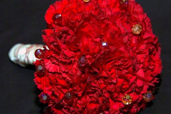 Red carnations with wire and bead accents.