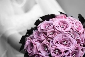 Lavender roses with diamond pins surrounded by dark purple calla lilies.
