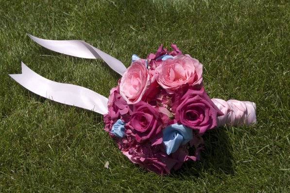 Pink roses and hydrangea with accents of ice blue ribbon.