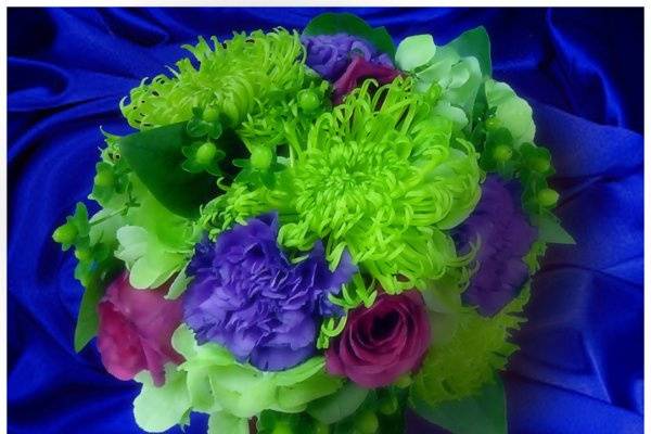 Bright bouquet of fuji mums, hydrangea, roses, carnations, and berries.