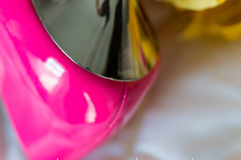 Wedding rings on hot pink shoes with chrome heel