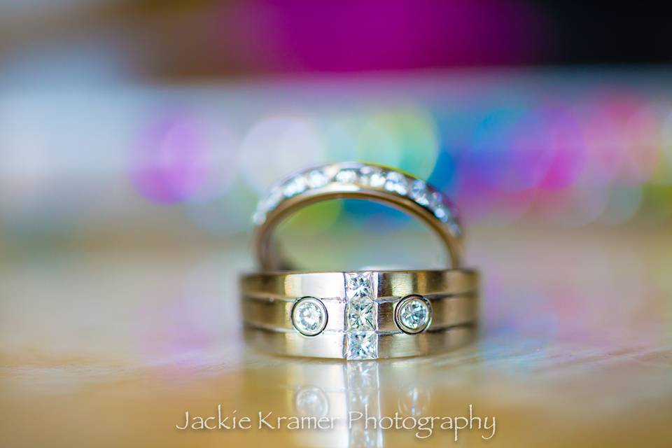 Wedding rings with cellphone bling in background