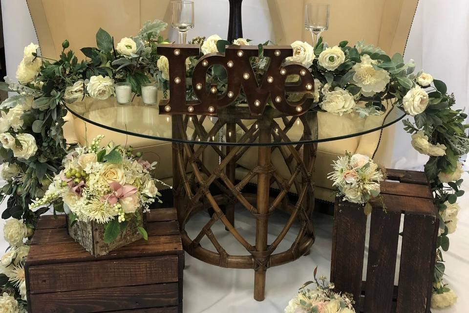 Glass topped table with off white flowers