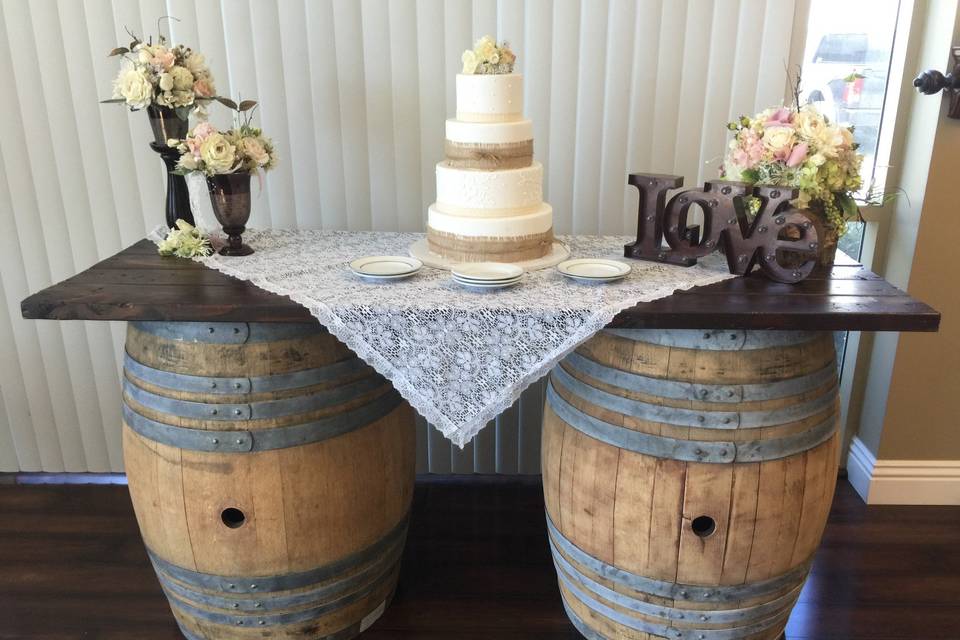 Wedding cake table featuring vintage barrels