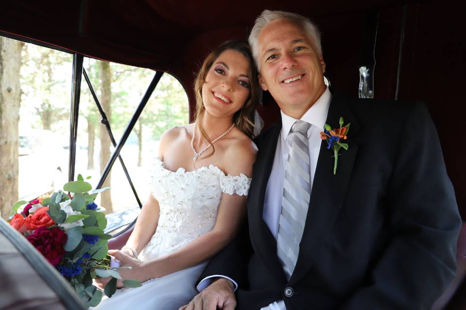 Father and bride in carriage