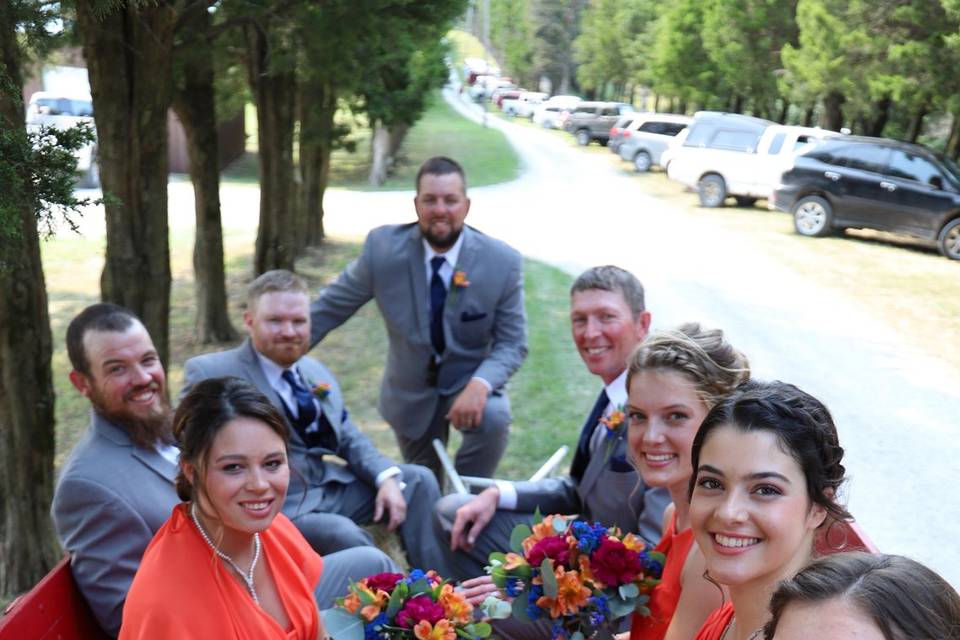 Wedding party in hay wagon