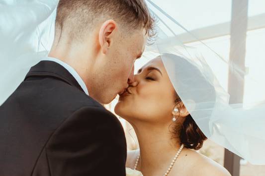Couple kiss under veil