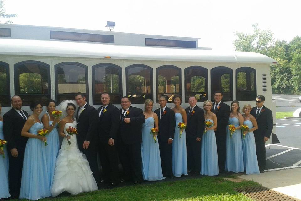 Newlyweds and their guests outside the trolley