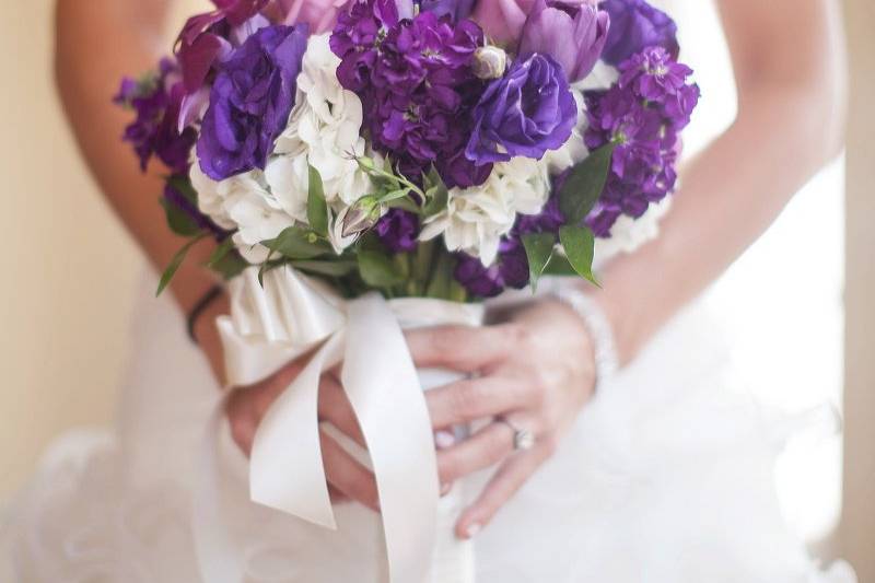 Bride holding a purple bouquet
