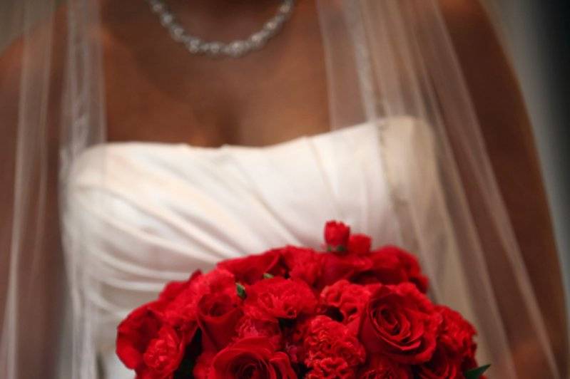 Bride holding a red bouquet