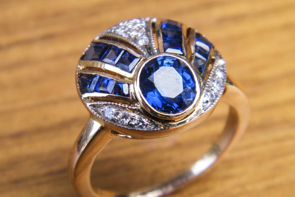 A beautiful antique Art Deco piece realized in yellow gold, diamonds, and sapphires.