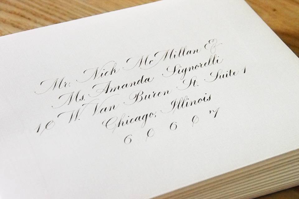 Black ink in a Copperplate script on white linen envelopes