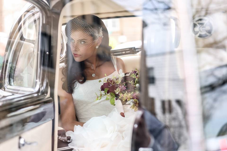 Bride glancing out of the car
