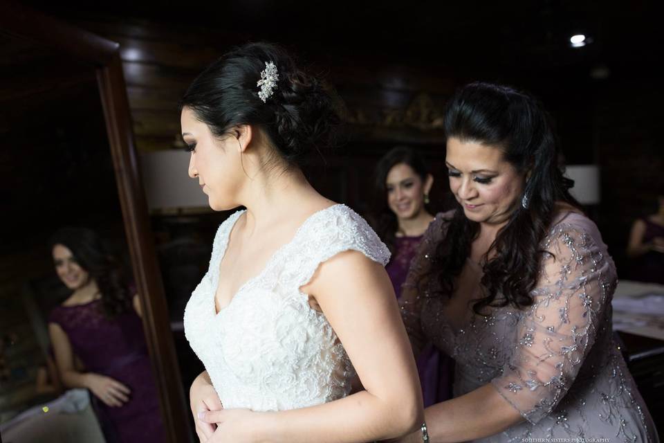 The bride putting on her dress
