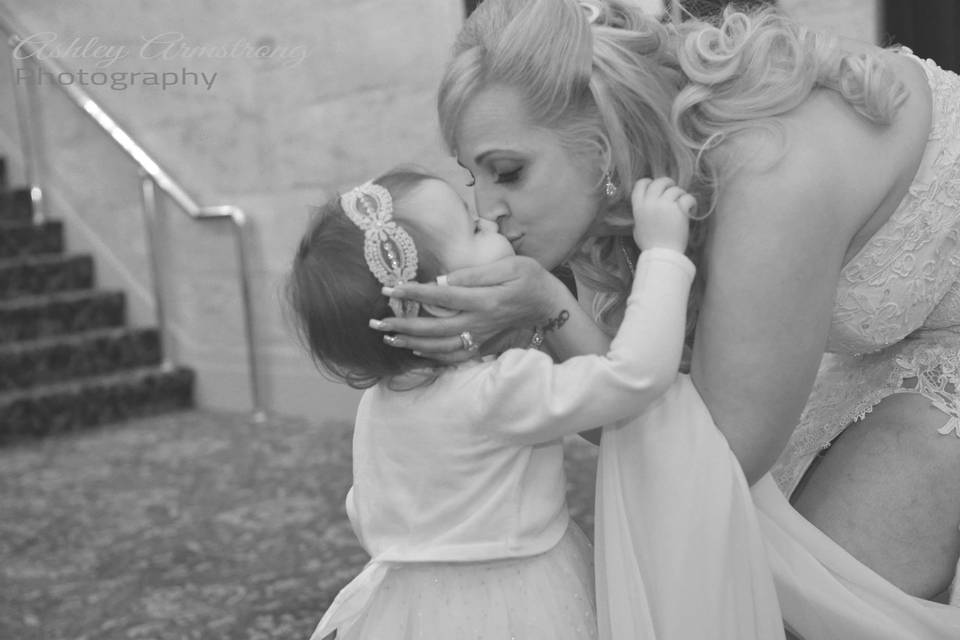 Bride kissing her child