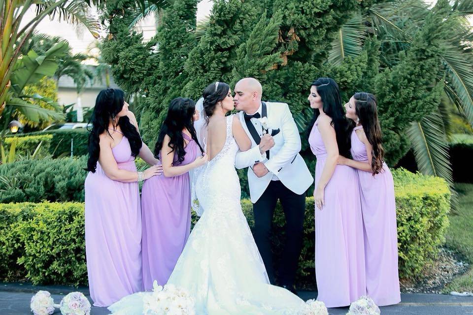 Sweet newlyweds with bridesmaids