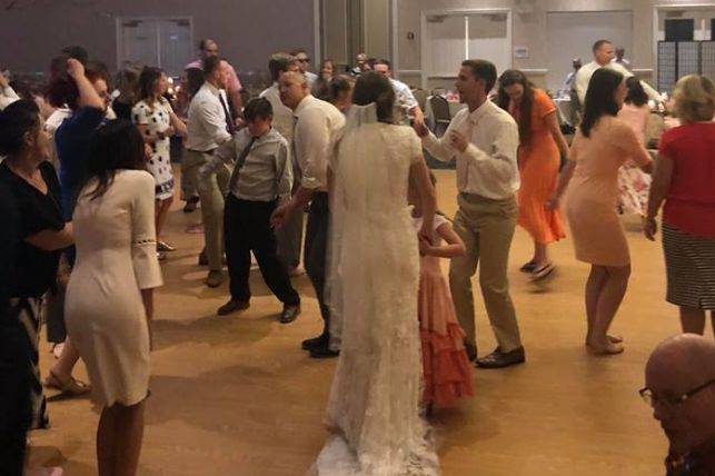 Newlyweds with their guests on the dance floor