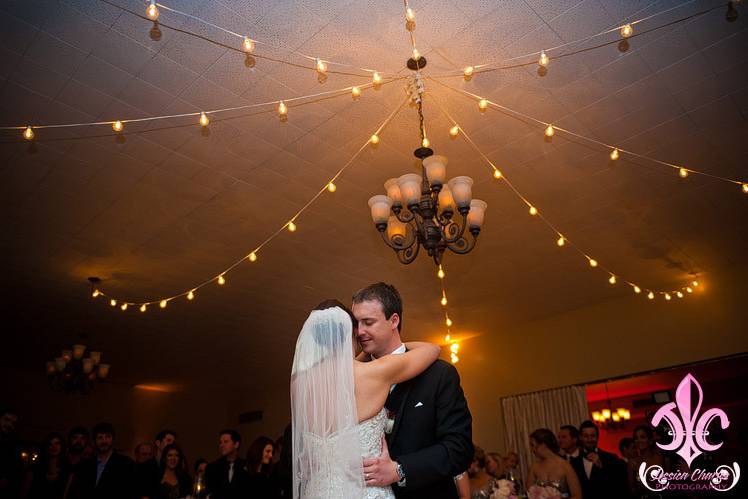 Newlyweds dancing underneath the lights