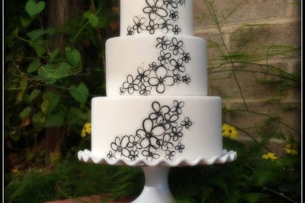 Hand painted whimsical daisies on fondant.